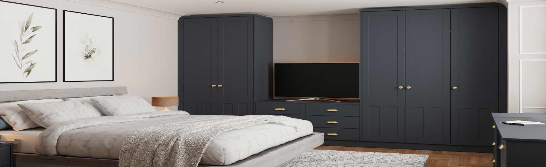 Modern bedroom with dark blue wardrobes, a large TV, and a cozy bed with a textured blanket. A light gray rug and wooden floor add warmth.