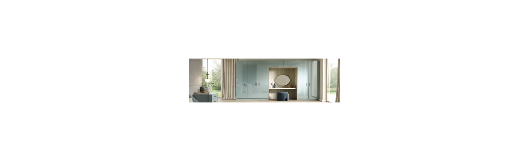 A modern bedroom features glossy pastel blue wardrobes with integrated vanity. A round mirror, decorative vases, and a soft velvet stool complete the elegant look.